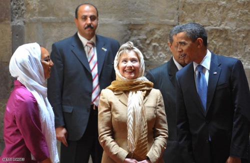 US President Barack Obama (R) and US Secretary of State Hillary Clinton (2R) listen to an explanation by an Egyptian-American art historian (L) as they tour the Sultan Hassan Mosque in Cairo, June 4, 2009. Obama took a tour of the medieval mosque in the heart of old Cairo on a trip aimed at repairing rifts with the Muslim world. AFP PHOTO/MANDEL NGAN (Photo credit should read MANDEL NGAN/AFP/Getty Images)
